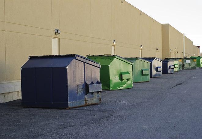 construction dumpsters stacked in a row on a job site in Shepherd